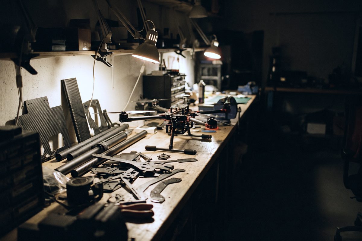 Composite parts under work lights in a small aerospace engineering lab